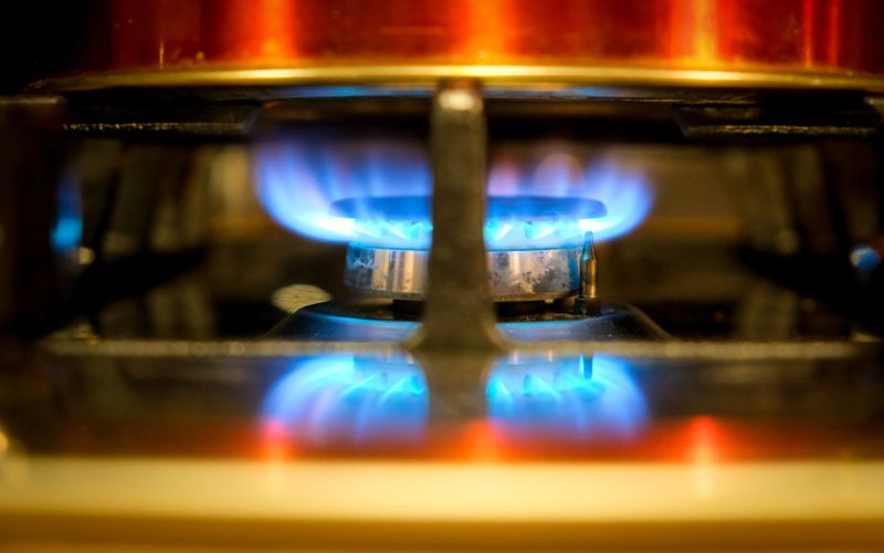 Close-up of a blue flame on a gas stove burner in a modern kitchen — best gas cookers and 4-burner stoves in Uganda