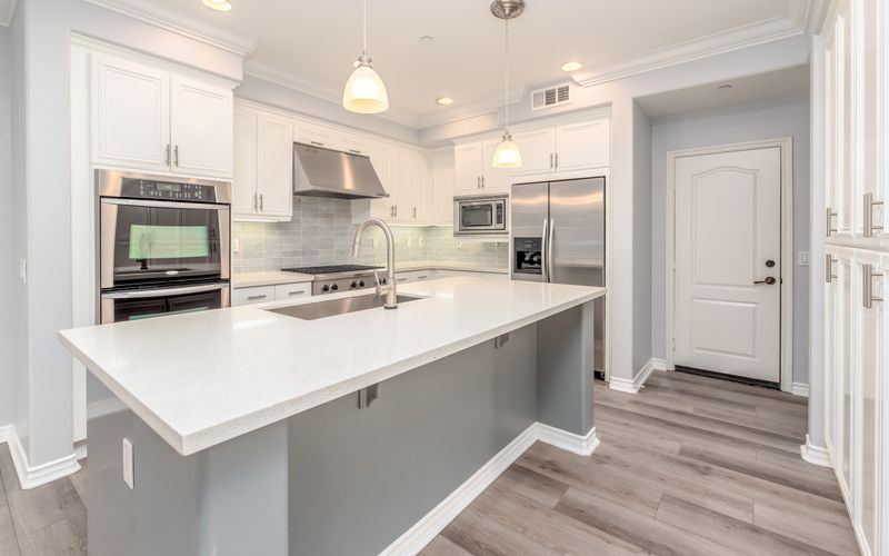 Modern kitchen interior with sleek white cabinetry and stainless steel appliances — best kitchen appliances in Uganda 2026