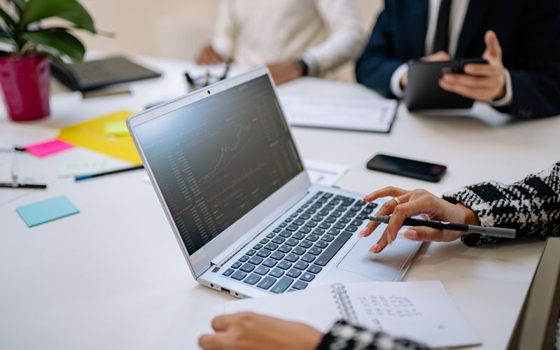 Person using a laptop in a business meeting — best laptops in Uganda 2026
