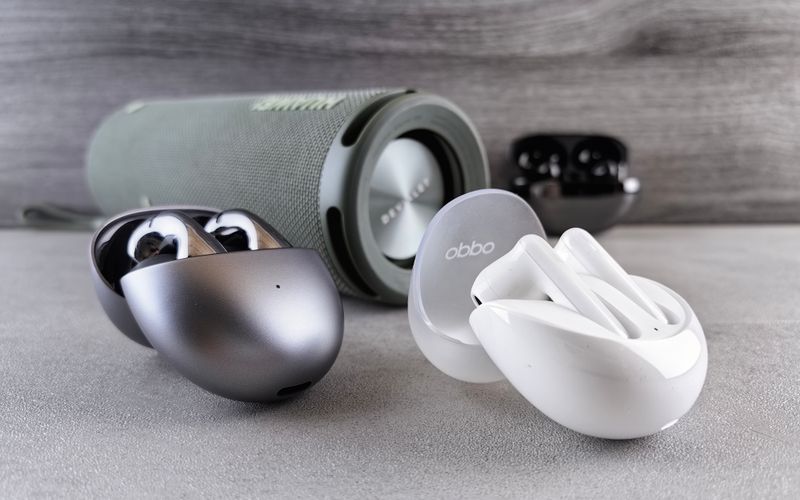 Multiple portable Bluetooth speakers and wireless earphones on a modern surface — JBL vs Sony vs Anker comparison guide