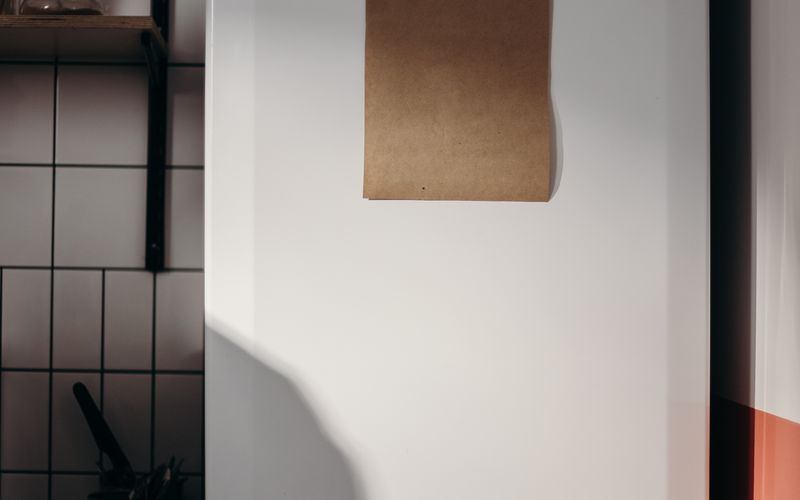 Cozy home kitchen with a blank paper on the fridge, ideal for budget-friendly appliance setting